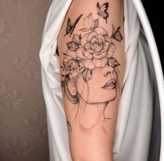 a woman's arm with a flower and butterfly tattoo on the left side of her body