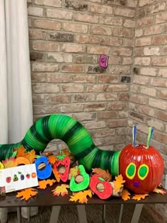 the very hungry caterpillar has been decorated with leaves and pumpkins for halloween