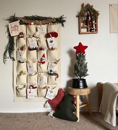 a christmas tree and stockings hanging on a wall next to a small table with a potted plant