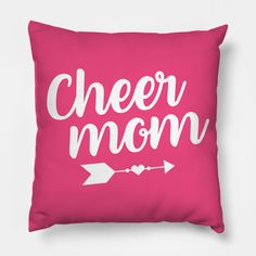 a pink pillow that says cheer mom with an arrow on the front and white lettering