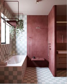 a bathroom with pink walls and checkered tile flooring is shown in this image