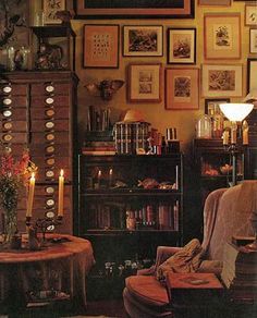 a living room filled with lots of furniture and pictures on the wall next to a book shelf