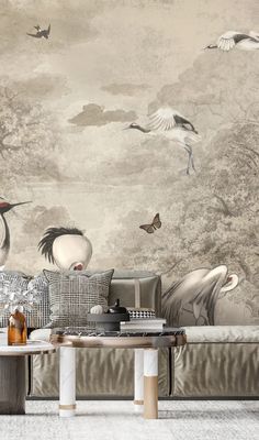 a living room filled with furniture and wallpaper covered in birds flying over the trees