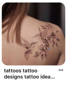 the back of a woman's shoulder with flowers on it and hummings flying around