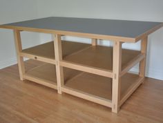 a wooden table with two shelves on each side