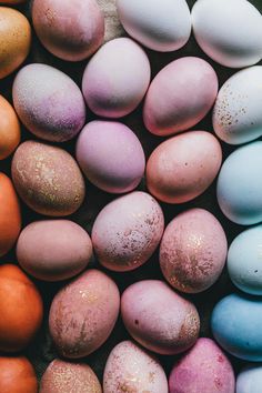 several different colored eggs sitting next to each other