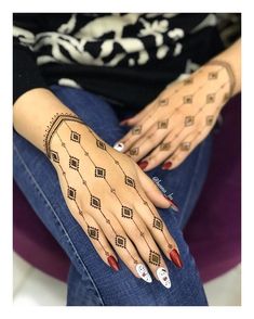 a woman's hand with tattoos on it