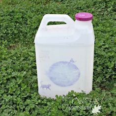 a gallon of milk sitting in the grass