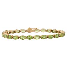 This Peridot Tennis Bracelet in 18K gold showcases 26 endlessly sparkling natural peridot, weighing 18.5 carats. It measures 7.25 inches long in length. Peridot attracts love and calms anger by giving renewal to all things. Designed with perfect oval cut peridot set horizontally to make you stand out on any occasion or event. The elegant style complements the attire beautifully and this is a perfect Unique Gift, Bridal Shower Gift, Secret Santa Gift, Gift For Sister, Mother Daughter Gift, Bride Peridot Color, Peridot Bracelet, Bracelet Tennis, Mother Daughter Gifts, Peridot Stone, Secret Santa Gift, Gift For Sister, Tennis Bracelet Diamond, Bridal Shower Gifts