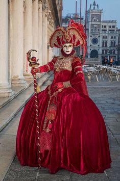 This striking clear image of a female participant in the Venice Carnival is posing for the camera to reveal her beautiful eyes inside the ornate, hand painted traditional mask.  Venice Carnival happens once a year before Easter and lasts two weeks. I have photographed this unique event twice so far and I want to return to do it again. Venice is both classic and romantic and the variance in Venetian costumes makes each carnival unique.  People from all over the world come to attend and most participate even if it involves wearing only a small mask.  The costumes cost in the thousands of dollars and on some nights, large balls are filled with costumed revelers who are donned in glorious fabric, vintage dress shoes, hand painted masks and elaborate wigs. As a photographer, I am constantly see Traditional Red Costume Masks And Prosthetics, Traditional Red Masks And Prosthetics For Costume, Traditional Masquerade Mask For Carnival, Traditional Red Masks And Prosthetics For Costume Party, Red Costume Masks For Festivals, Red Masks And Prosthetics For Costume Festivals, Red Masks And Prosthetics For Festivals, Traditional Red Masquerade Mask For Carnival, Traditional Masquerade Mask For Theater Festivals