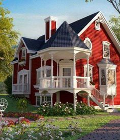 a large red house with white balconies