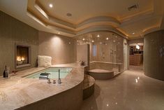 a large bathroom with a jacuzzi tub next to a fire place