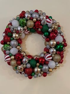 a christmas wreath with ornaments hanging from it