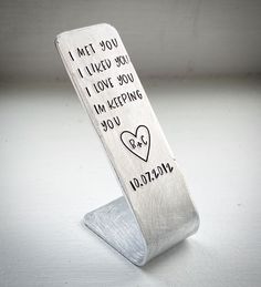 a metal bookmark with writing on it that says i met you, i love you, i'm keeping you