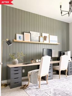 a desk with two chairs and a computer on top of it in front of a gray wall