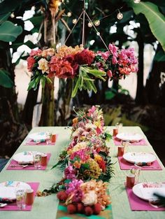 the table is set with flowers and plates