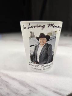 a coffee cup with an image of a man in a cowboy hat on the side