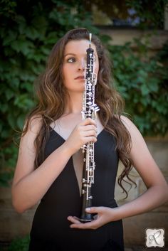 a woman holding a flute in her hands