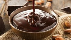 a bowl filled with chocolate and nuts on top of a table