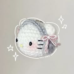 a crocheted hello kitty keychain hanging from the side of a wall