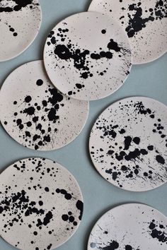 six black and white plates sitting on top of a table