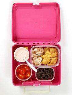 a pink lunch box filled with lots of food