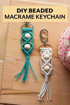 two macrame keychains are sitting on a wooden board with the words diy beaded macrame keychain