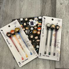 three pens with cartoon faces on them are sitting next to each other in the package