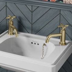 a bathroom sink with two faucets on the side and a mirror above it