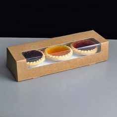 two trays filled with different types of condiments on top of a table