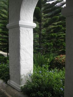 an arch in the middle of a garden