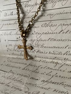 Handmade gold chain necklace with an ornate antique Turkish crucifix pendant. The crucifix is antique, the chain is also antique and has no fastening due to the long length. Handmade item incorporating antique elements.  This is a delicate piece and should not be exposed to perfumes or harsh chemicals.  Unique and one of a kind! I can gift wrap this also. Vintage Engraved Cross Necklace Gift, Vintage Cross Chain Jewelry, Vintage Brass Cross Pendant Jewelry, Vintage Cross Necklace With Antique Finish, Antique Gold Ankh Jewelry, Vintage Cross Pendant Jewelry With Adjustable Chain, Antique Brass Cross Pendant Jewelry, Antique Gold Necklace With Chain, Vintage Engraved Ankh Jewelry