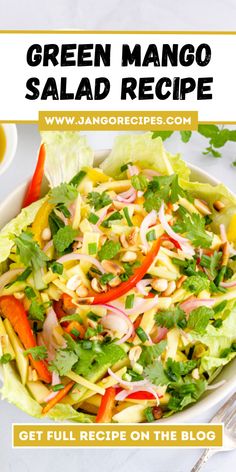 green mango salad recipe with lettuce, carrots and red onions in a white bowl