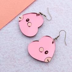 The heart fish pocket monster. They are pink and and pastel with black eyes, and engraved details. Earrings are a pair. Brooches are available and sold as 1 piece. Hardware is silver-toned (add a note at checkout if you prefer gold-toned). Dimensions: Dangle Earrings: 1.5 in (38 mm) L x 1.4 in (35 mm) W        The drop length is about 2.0 in (51 mm). Brooch: 2.4 in (60 mm) L x 2.2 in (56 mm) W Materials: Mirror Acrylic Hypoallergenic, Nickel Free, Stainless Steel Shipping: All of our earrings are made-to-order to cut down on waste. Your earrings will be produced and shipped within a week after you order. Care: Do not soak earrings in water. Materials are water resistant, but it is not recommended that you swim, shower, or bath with your earrings on. Avoid getting lotions, oils, and perfume Kawaii Heart Earrings For Valentine's Day, Pink Kawaii Heart Earrings For Valentine's Day, Pink Kawaii Earrings For Valentine's Day, Kawaii Pink Earrings For Valentine's Day, Valentine's Day Pink Kawaii Earrings, Valentine's Day Kawaii Heart Earrings, Valentine's Day Kawaii Pink Earrings, Cute Pink Pierced Heart Earrings, Cute Pink Heart Pierced Earrings