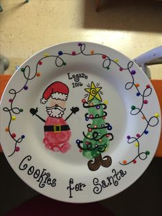 a white plate with a christmas tree and santa clause on it, sitting on top of a table