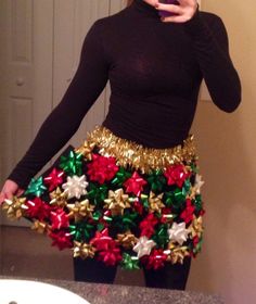 a woman taking a selfie with her cell phone wearing a skirt made out of bows