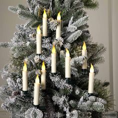 a christmas tree with lit candles in it