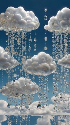 many clouds are floating in the sky with drops of water hanging from it's sides