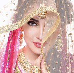 a beautiful woman wearing a veil and jewelry