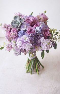 a vase filled with purple flowers on top of a table