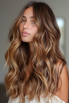 Long waves with a sun-kissed bronze balayage are making a statement in 2024. This look combines the natural flow of waves with the radiant warmth of bronze, creating a stylish and luminous appearance.