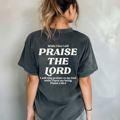 This Praise the Lord t-shirt with Psalm 146:2 Bible verse on the back is a great way to proclaim your faith! Trendy Christian graphic tees like this Praise The Lord shirt can make a bold statement in sharing your love for the Lord and serve as a reminder to Praise Him in all you do! Plus, it's a great way to share God's word and plant seeds of faith anywhere you go! This cute Christian t-shirt is versatile to create a cool Christian street style with sweats or joggers. Or size up and pair it wit Inspirational Crew Neck T-shirt With Lettering, Inspirational Lettering Crew Neck T-shirt, Christian Sayings For Shirts, Cute Christian Shirts, Christian Graphic Tees, Praise Him, Praise The Lord, Plant Seeds, Cricut Craft