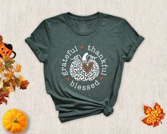 Thankful Grateful And Blessed T-Shirt, Thanksgiving Shirt, Blessed Shirt, Pumpkin Tee, Pumpkin Patch Shirt, Autumn Shirt, Thankful Shirt NOTE: We use black design for White, Light Grey Heather( Athletic Heather), Pink, Heather Peach, Mint Green, Burnt Orange colors. For other colors we will use white design. Hi There! First of all thank you for being here and checking out our finest t-shirt designs.  We dedicated ourselves to provide the best possible service for our valuable customers. In order to provide you best service, we are using the quality materials and beautiful designs. You can always contact us for your questions or for your suggestions. We are open for your suggestions. ✔ How To order; 1-) Please, check and review all photos 2-) Choose your t-shirt size and color 3-) Click add Green Screen Print Shirt For Fall, Green Graphic Tee For Fall, Printed Graphic Tee Shirt For Fall, Graphic Tee Shirt With Fall Print, Fall Graphic Tee With Printed Design, Green Screen Print T-shirt For Fall, Fall Graphic Tee Shirt With Printed Details, In All Things Give Thanks Shirts, Fall Thankful Tshirt