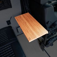 a wooden table sitting in the back of a van