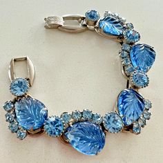 Beautiful Vintage Julianna Rhinestone Bracelet. Features Molded Blue Leaf Stones Of Unknown Material And Blue Rhinestones In Unknown Silvertone Metal. Unsigned, But I Have Seen This Bracelet Online Noted As A Verified Julianna Piece. Condition: Overall Good Vintage Condition With Light Surface Wear Including Light Scratching And Some Flea Bites To Stones, Mainly Visible Under Magnification. *Jewelry Contains Small Parts Or Components Which Could Pose A Choking Hazard If Ingested. Our Jewelry Is Not Recommended For Use By Children And Should Be Stored In Areas Away From Children. Shipping: I Ship Within 3 Business Days Of Receiving Your Completed Payment. My Business Days Are Monday-Frida Jewelry 2024, Bracelet Blue, Bracelet Online, Blue Leaves, Rhinestone Bracelet, Blue Rhinestones, My Business, Womens Jewelry Bracelets, Vintage Jewelry