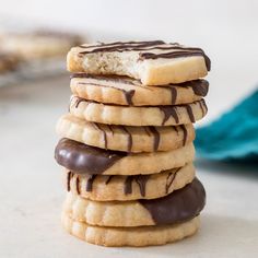 a stack of cookies with chocolate drizzled on top