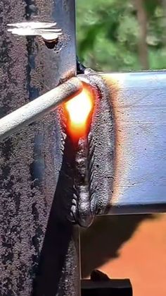 a close up of a metal object with an orange light coming out of it's center