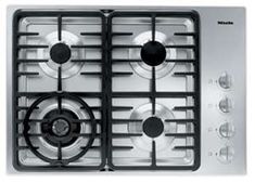 a gas stove top with four burners