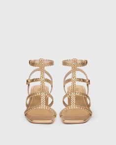 This Grecian-inspired city heel sandal is crafted from incredibly luxe metallic gold leather and features flat braided straps, a soft square toe shape, a slightly flared upper wrapped block heel, and light gold metal full buckle closures. The top two adjustable straps allow for versatile fitting and our signature cushioned insole guarantees a comfortable fit from morning to moonlight. | Eliza Sandal - Gold Leather | Size 7 Godmother Outfit, Men Store, Braided Strap, Denim Shoes, Heel Sandal, Gold Leather, Ancient Egypt, Metallic Gold, Gold Metal