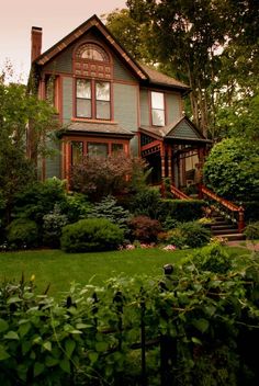 the house is surrounded by trees and bushes